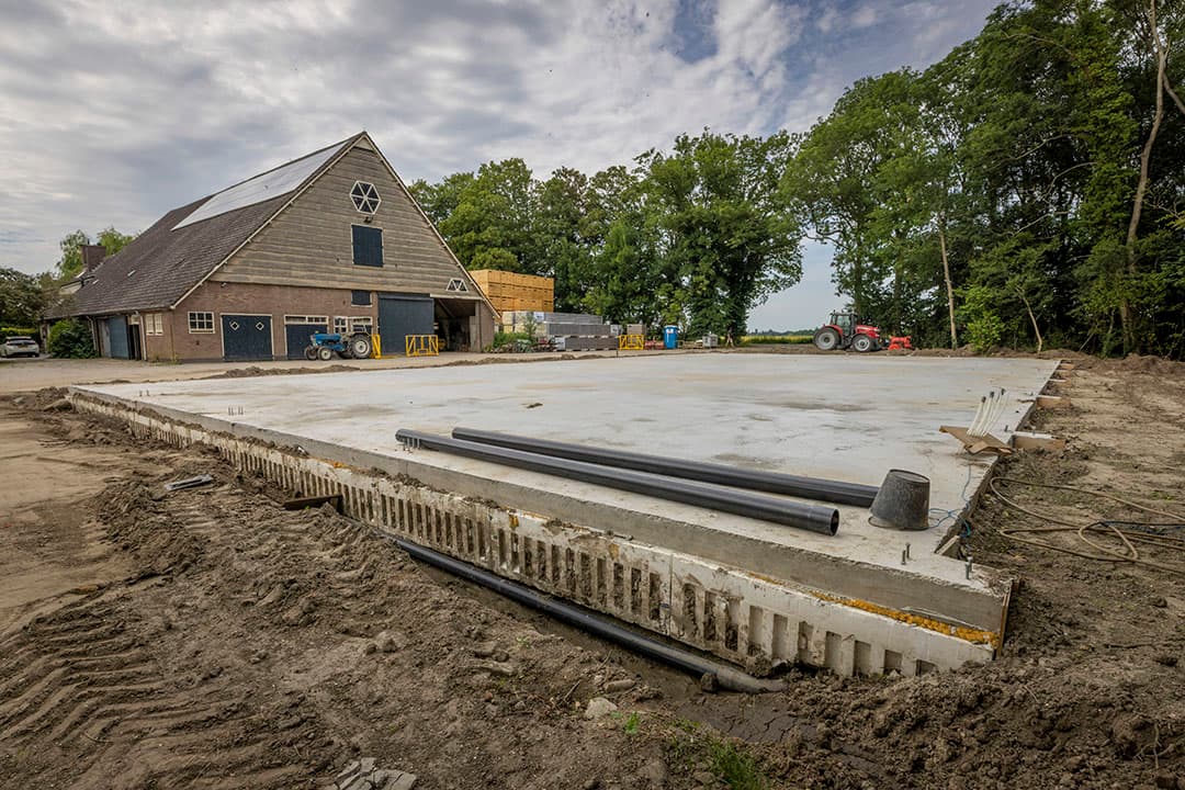 Nieuwe loods in aanbouw voor kistenopslag van producten. Twee keer langer en breder dan de oude op die plek, ook hoger.