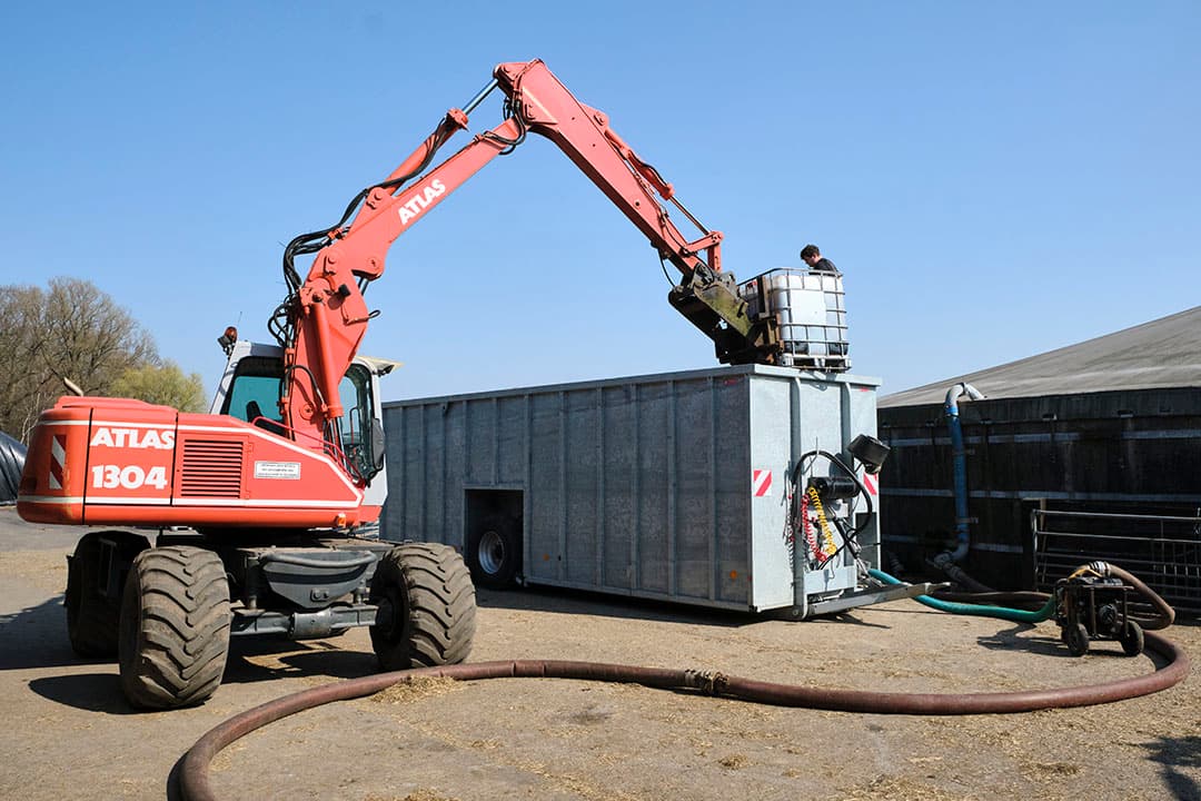 Het spuiwater wordt met een kraan gelost uit de kuubs-containers en zo vermengd met drijfmest. Per hectare is een ton spuiwater gebruikt. - Foto: Roel Dijkstra