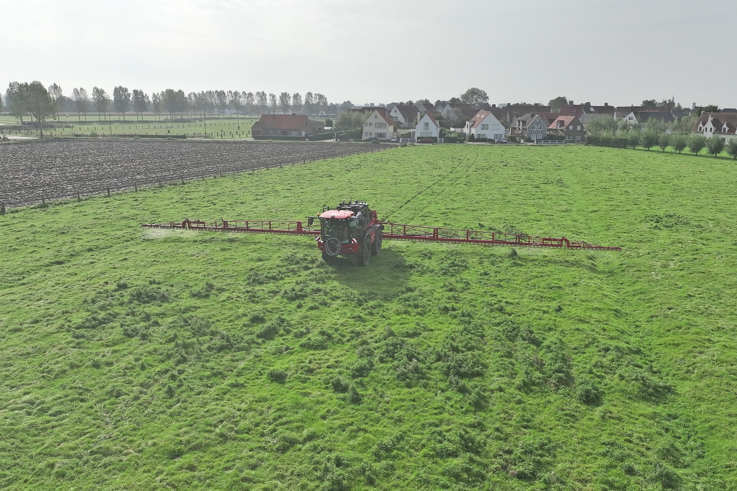 Een bekend beeld en toch bijzonder. De veldspuit op de foto detecteert en spuit de ridderzuring niet met behulp van camera’s. Hij werkt op basis van een taakkaart, gegenereerd na het uitvoeren van een dronevlucht. - Foto: Croptic