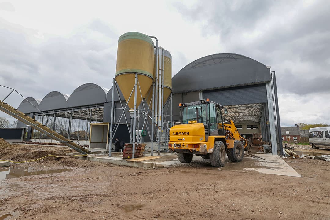 Een overzicht van de achterkant van de koeientuin waar straks de afvoer van de vaste mest plaatsvindt. Dit gebeurt met een uitmest-/opvoerketting (links nog net in beeld). Inmiddels zijn ook de eerste silo’s geplaatst.