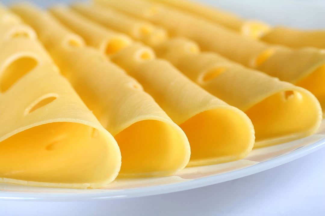 Royal A-ware produceert onder andere merkkazen zoals Royal Orange, Westzaner en A-cheese. - Foto: Canva