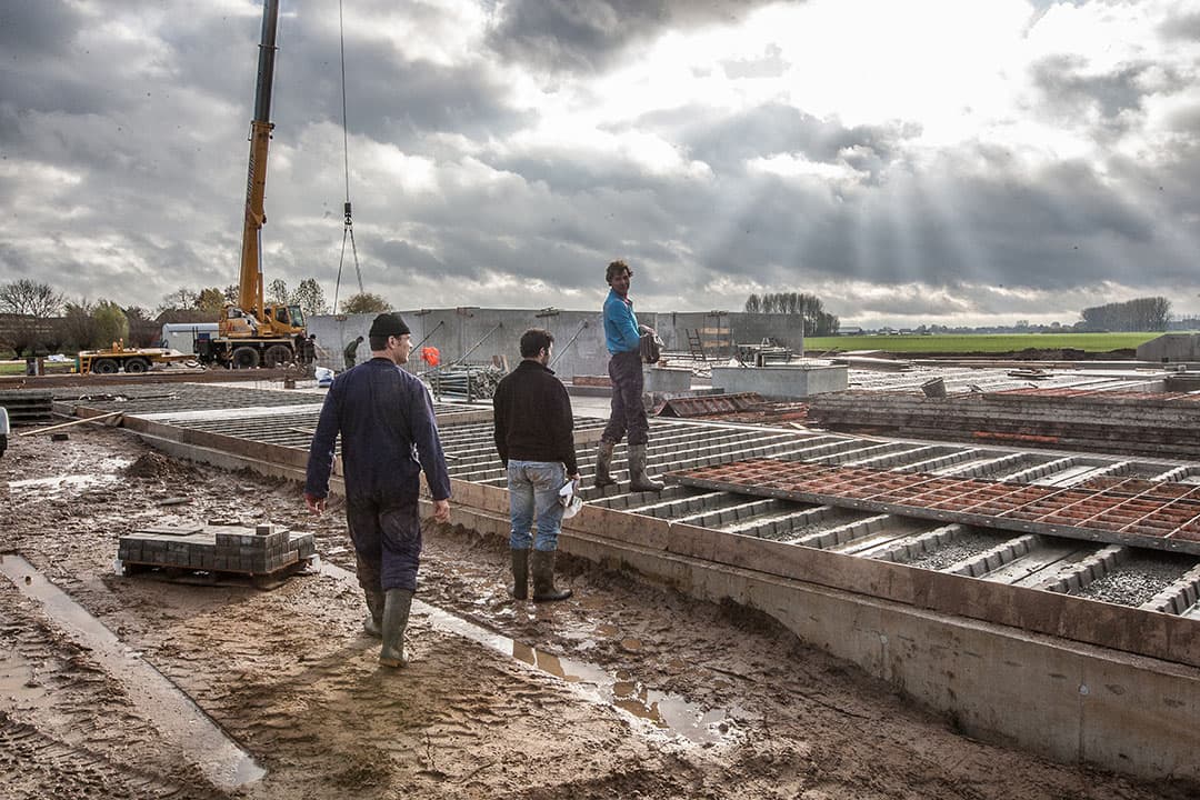 Bouw van een stal. Voorwaarden aan nieuwbouw van stallen worden uitgebreid. Er gelden niet alleen eisen voor emissie-reductie, maar ook voor de veiligheid. - Foto: Ronald Hissink