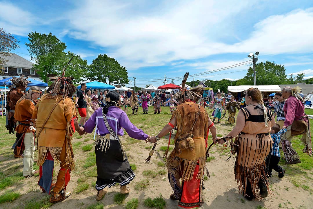 Native Americans of different tribes take part in a circle/friendship dance during the 29th Annual Spring Planting Moon Pow Wow run by the Massachusetts Center for Native American Awareness at the Marshfield Fair Grounds in Marshfield, Massachusetts, May 25, 2019.