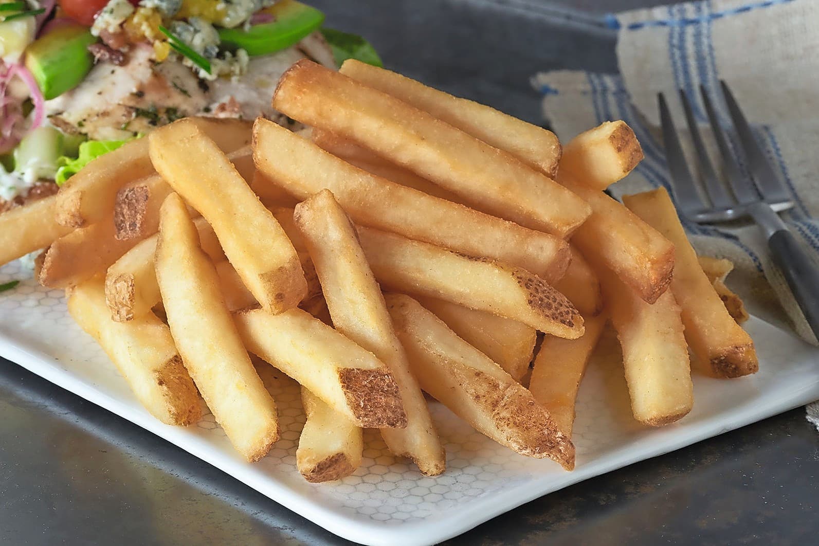 Frites van Lamb Weston. De aardappelverwerker is wereldwijd aan het saneren. Foto: Lamb Weston