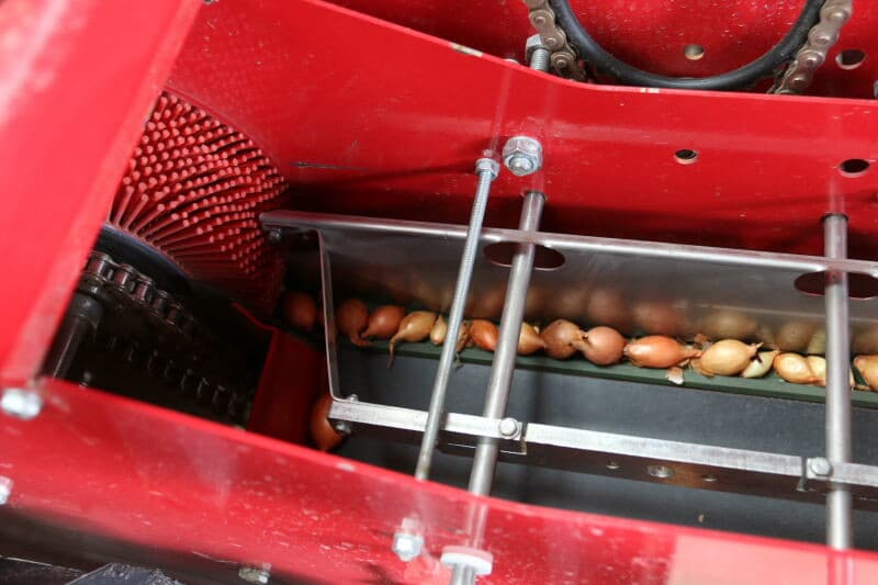 De tandwieloverbrenging van het aandrijfmechaniek, waarmee de plantafstand wordt ingesteld.